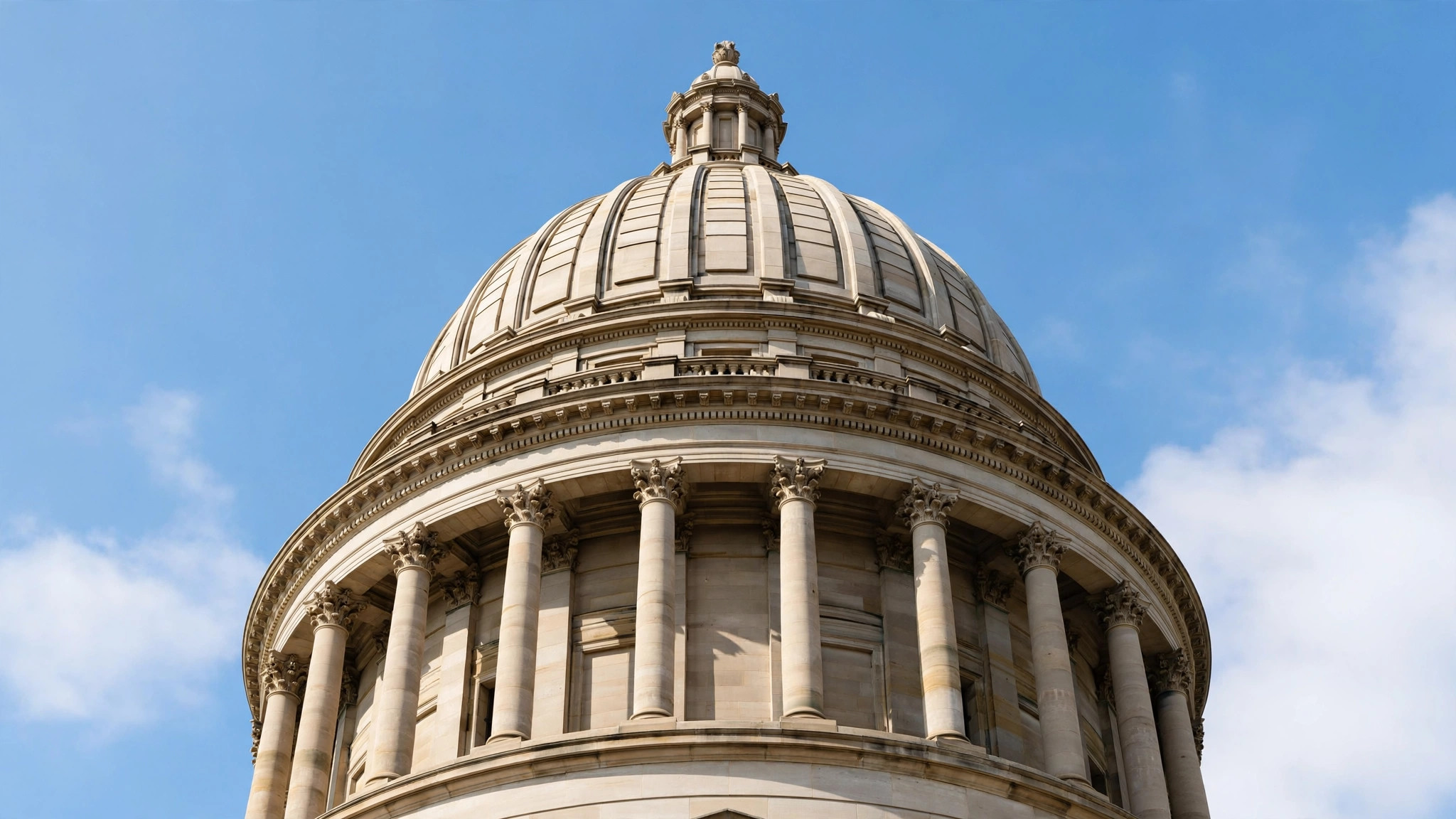 Dome of a capitol building against a blue sky
