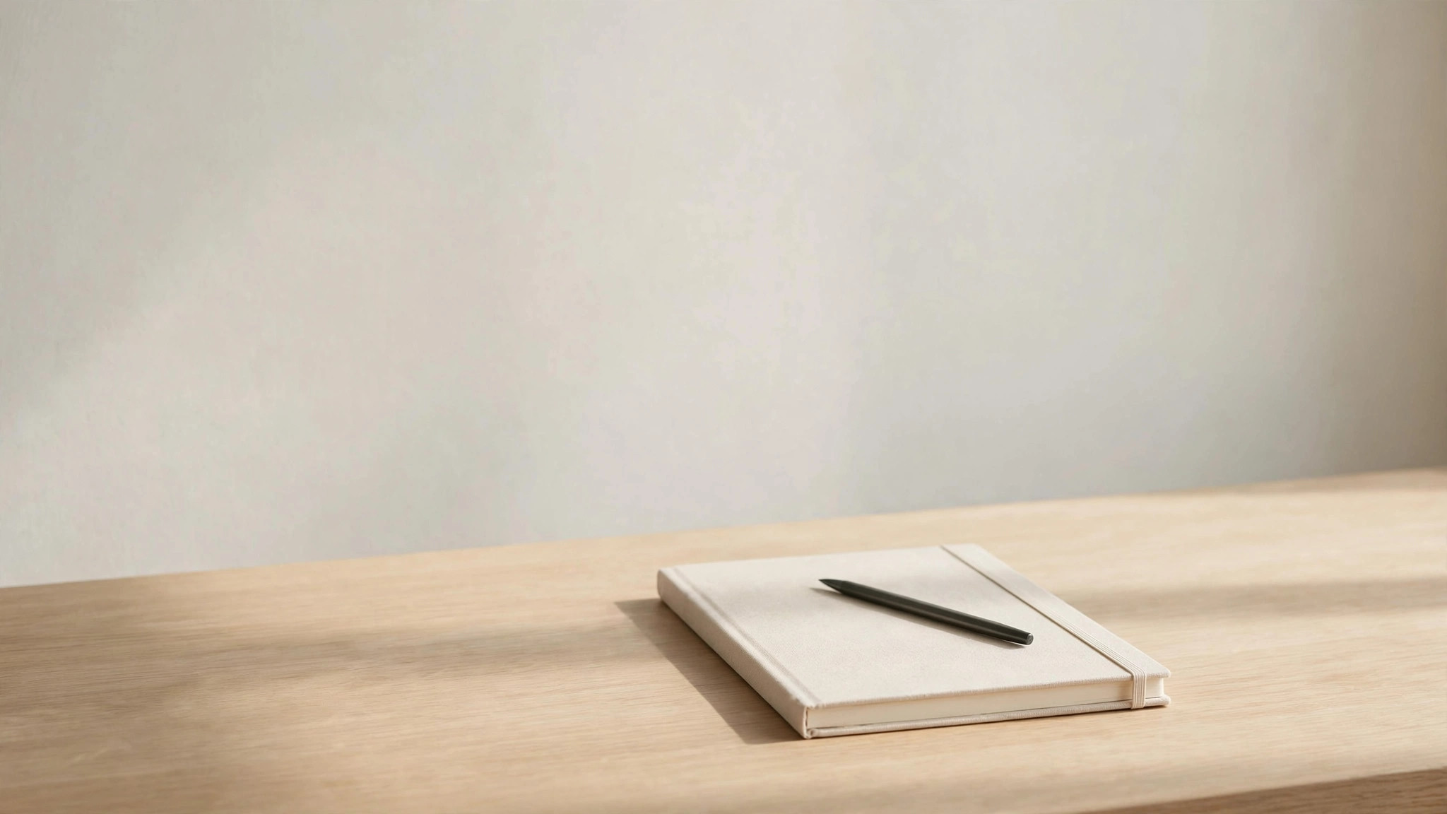 Minimalist empty desk with blank notebook and pen