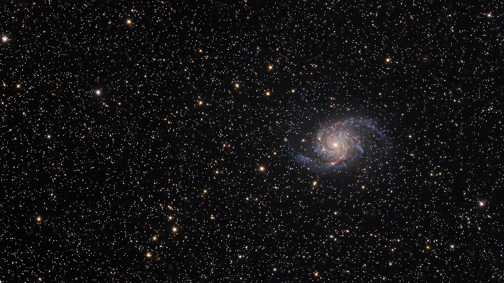 Starfield in deep space with a distant galaxy